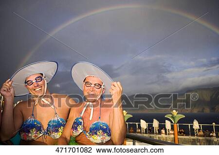 Two gay men wearing bikini tops and dancing View Large Photo Image Stock Image - Two gay men wearing bikini tops and dancing. Fotosearch