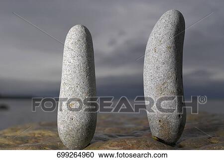 Two pebbles on a rock View Large Photo Image Stock Image - Two pebbles on a rock. Fotosearch