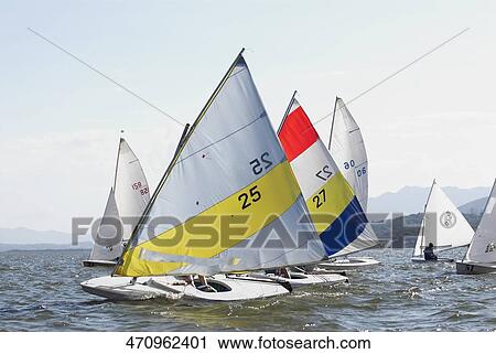 Two people participating in a sailboat race View Large Photo Image Stock Image - Two people participating in a sailboat race. Fotosearch