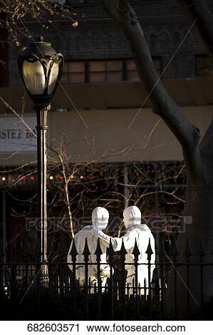 Two statues behind a fence View Large Photo Image Stock Image - Two statues behind a fence. Fotosearch