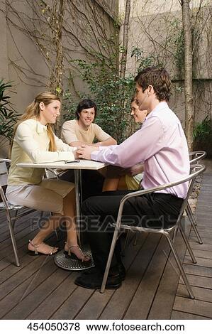Two young couples sitting in a cafe View Large Photo Image Stock Photo - Two young couples sitting in a cafe. Fotosearch