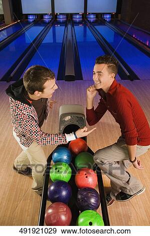 Two young men dancing in a bowling alley View Large Photo Image Stock Photo - Two young men dancing in a bowling alley. Fotosearch