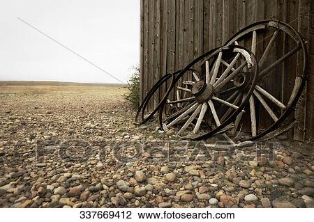 Wagon wheels leaning against the wall of an abandoned building, Old Trail Town, Cody, Wyoming, USA View Large Photo Image Stock Image - Wagon wheels leaning against the wall of an abandoned building, Old Trail Town, Cody, Wyoming, USA. Fotosearch