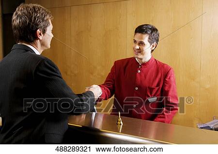 Waiter giving cardkey to a businessman View Large Photo Image Stock Image - Waiter giving cardkey to a businessman. Fotosearch