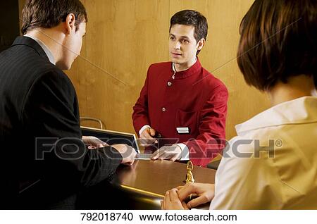 Waiter giving information to customers View Large Photo Image Stock Image - Waiter giving information to customers. Fotosearch