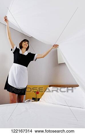 Waitress making the bed View Large Photo Image Picture - Waitress making the bed. Fotosearch