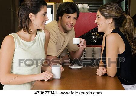 Waitress talking with two customers at a counter View Large Photo Image Stock Image - Waitress talking with two customers at a counter. Fotosearch