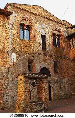 Well in front of a building, San Gimignano, Siena Province, Tuscany, Italy View Large Photo Image Stock Photograph - Well in front of a building, San Gimignano, Siena Province, Tuscany, Italy. Fotosearch