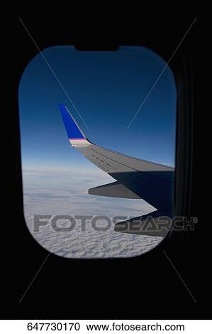 Wing of an airplane viewed through a window View Large Photo Image Stock Image - Wing of an airplane viewed through a window. Fotosearch