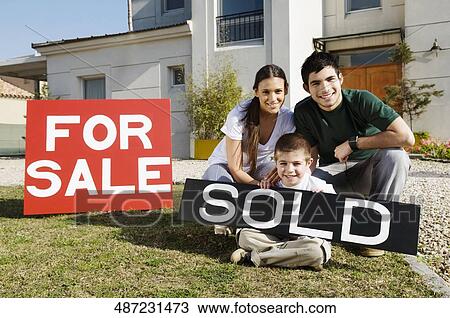 Young couple and their son sitting with a sold information board View Large Photo Image Stock Image - Young couple and their son sitting with a sold information board. Fotosearch