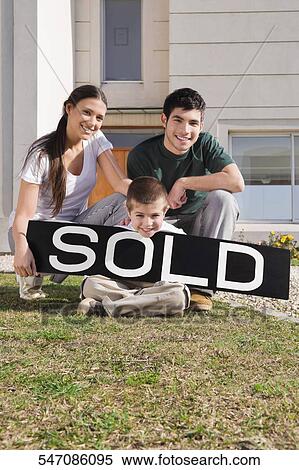 Young couple and their son sitting with a sold information board View Large Photo Image Stock Photography - Young couple and their son sitting with a sold information board. Fotosearch