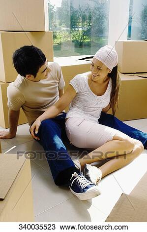 Young couple looking at each other and smiling View Large Photo Image Stock Image - Young couple looking at each other and smiling. Fotosearch