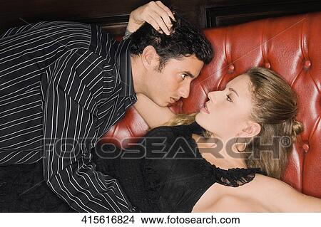 Young couple romancing on a booth View Large Photo Image Picture - Young couple romancing on a booth. Fotosearch