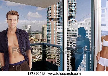 Stock Image - Young couple standing in a balcony. Fotosearch