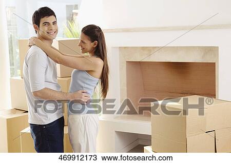 Young couple standing together and smiling View Large Photo Image Stock Image - Young couple standing together and smiling. Fotosearch