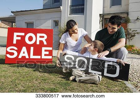 Young couple with their son sitting near for sale information board and smiling View Large Photo Image Stock Photo - Young couple with their son sitting near for sale information board and smiling. Fotosearch