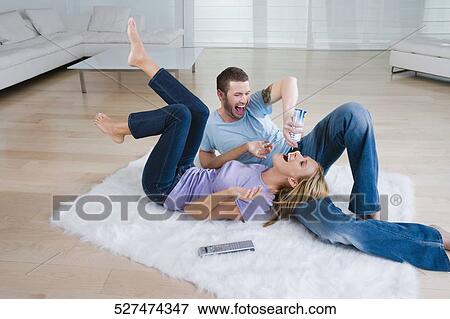 Young man feeding whipped cream from a bottle to a mid adult woman View Large Photo Image Stock Photo - Young man feeding whipped cream from a bottle to a mid adult woman. Fotosearch