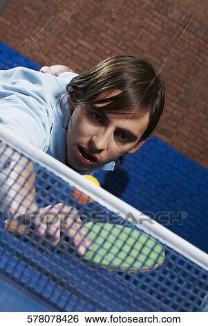 Young man playing table tennis View Large Photo Image Stock Photograph - Young man playing table tennis. Fotosearch