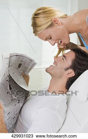Stock Image - Young man smiling with a mid adult woman. Fotosearch