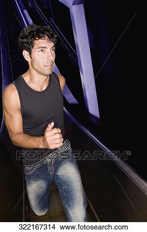 Young man walking in the corridor View Large Photo Image Picture - Young man walking in the corridor. Fotosearch