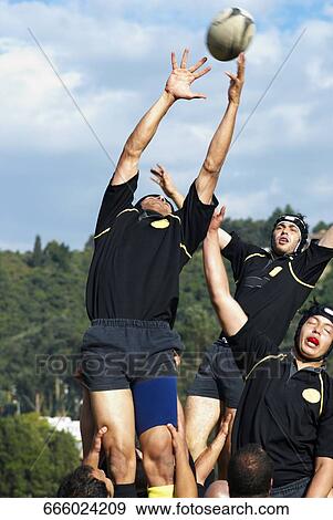 Stock Photo - Young men playing rugby. Fotosearch