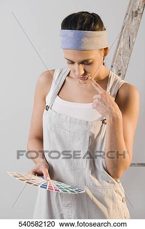 Young woman choosing color from a color swatch View Large Photo Image Stock Image - Young woman choosing color from a color swatch. Fotosearch