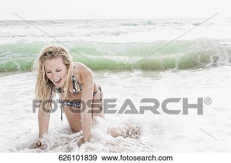 Young woman enjoying on the beach View Large Photo Image Stock Photo - Young woman enjoying on the beach. Fotosearch