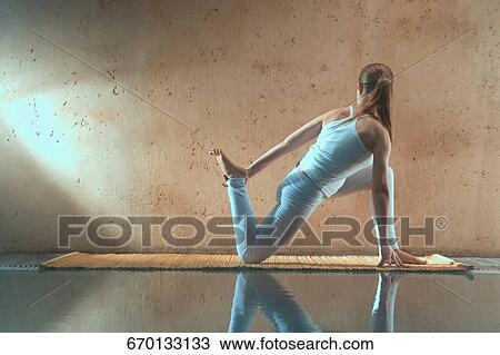 Young woman exercising at the poolside View Large Photo Image Stock Image - Young woman exercising at the poolside. Fotosearch