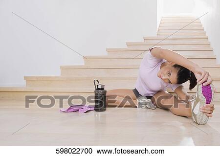 Young woman exercising on the floor View Large Photo Image Stock Image - Young woman exercising on the floor. Fotosearch