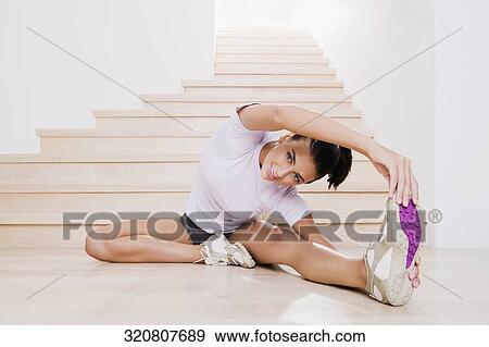 Young woman exercising on the floor View Large Photo Image Stock Photo - Young woman exercising on the floor. Fotosearch