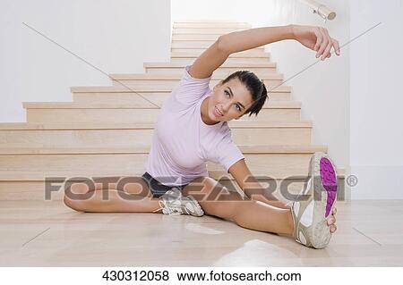Young woman exercising on the floor View Large Photo Image Stock Photo - Young woman exercising on the floor. Fotosearch