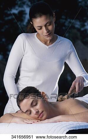 Young woman getting back massage from a massage therapist View Large Photo Image Stock Image - Young woman getting back massage from a massage therapist. Fotosearch