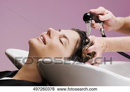 Young woman getting hair rinsed at salon View Large Photo Image Stock Photo - Young woman getting hair rinsed at salon. Fotosearch