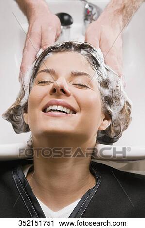 Young woman getting hair shampooed at the hair salon View Large Photo Image Stock Image - Young woman getting hair shampooed at the hair salon. Fotosearch