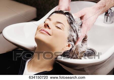 Young woman getting hair shampooed at salon View Large Photo Image Stock Image - Young woman getting hair shampooed at salon. Fotosearch