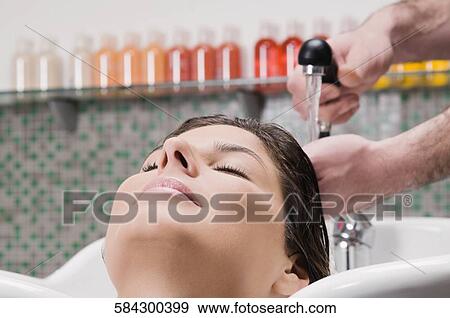 Young woman having hair washed in the hair salon View Large Photo Image Stock Photo - Young woman having hair washed in the hair salon. Fotosearch