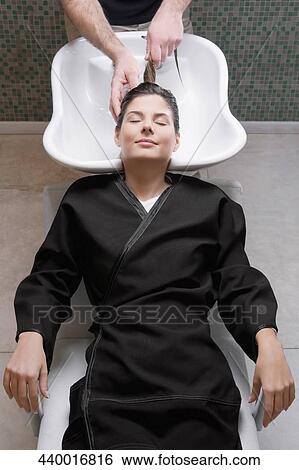 Young woman having hair washed in the hair salon View Large Photo Image Stock Photograph - Young woman having hair washed in the hair salon. Fotosearch