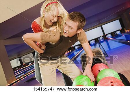 Young woman piggybacking a young man View Large Photo Image Stock Photo - Young woman piggybacking a young man. Fotosearch