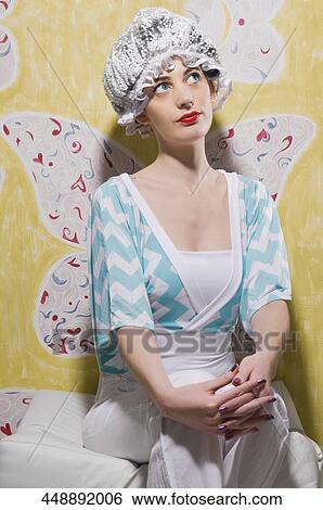 Young woman wearing a headdress and thinking View Large Photo Image Stock Photograph - Young woman wearing a headdress and thinking. Fotosearch