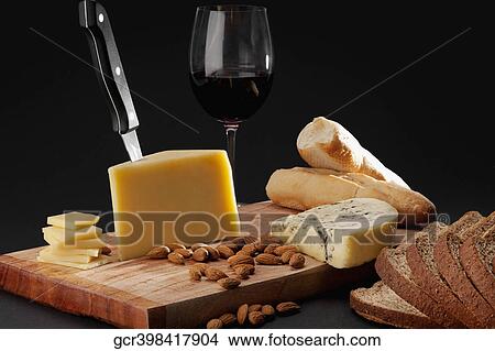 Assorted cheese served with red wine and bread View Large Photo Image Picture - Assorted cheese served with red wine and bread. Fotosearch