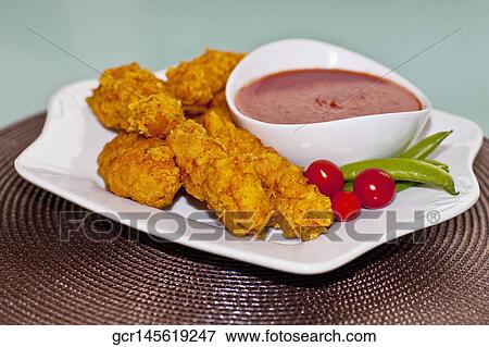 Batter fried chicken with ketchup View Large Photo Image Stock Photo - Batter fried chicken with ketchup. Fotosearch