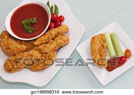 Batter fried chicken with ketchup View Large Photo Image Stock Photograph - Batter fried chicken with ketchup. Fotosearch