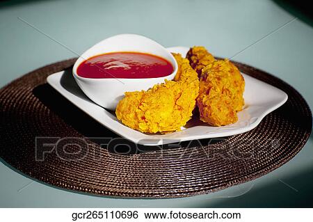 Batter fried chicken with ketchup View Large Photo Image Stock Photograph - Batter fried chicken with ketchup. Fotosearch