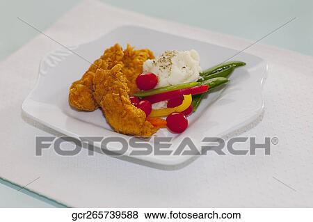 Stock Photo - Batter fried chicken with mashed potatoes. Fotosearch