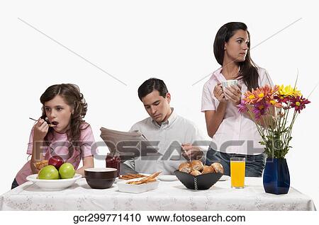 Bored family having breakfast together View Large Photo Image Stock Image - Bored family having breakfast together. Fotosearch