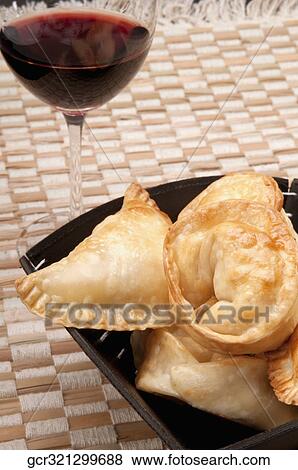 Bowl of panzarotti served with red wine View Large Photo Image Stock Photo - Bowl of panzarotti served with red wine. Fotosearch
