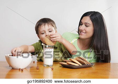 Boy and his mother at a breakfast table View Large Photo Image Stock Image - Boy and his mother at a breakfast table. Fotosearch