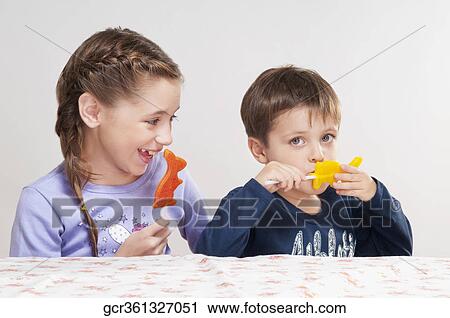 Boy and his sister holding candies View Large Photo Image Stock Image - Boy and his sister holding candies. Fotosearch