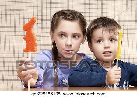 Boy and his sister holding candies View Large Photo Image Stock Photography - Boy and his sister holding candies. Fotosearch
