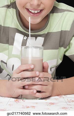 Boy drinking chocolate milkshake and smiling View Large Photo Image Stock Image - Boy drinking chocolate milkshake and smiling. Fotosearch